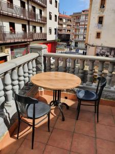 a table and two chairs on a balcony at Gernika Urdaibai in Guernica y Luno