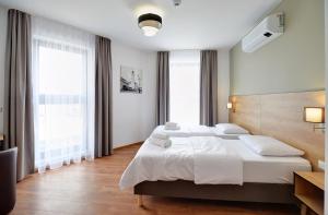 Łóżko lub łóżka w pokoju w obiekcie Nocleg EM
