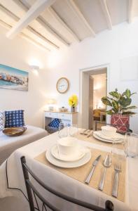 jadalnia ze stołem z talerzami i przyborami kuchennymi w obiekcie Sole Blu Mykonos Town Apartment One w mieście Mykonos