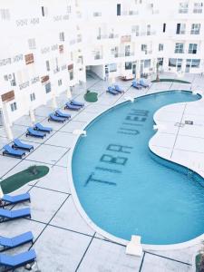 a swimming pool at a hotel with lounge chairs at Tiba View in Hurghada