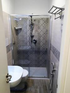 a bathroom with a shower with a toilet and a sink at B&B Marconi in Favignana