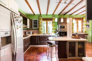 a kitchen with brown cabinets and green walls at 7 bedrooms villa with private pool enclosed garden and wifi at Padul in Padul