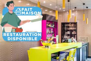 a restaurant with a yellow counter and a sign at ibis Styles Antony Paris Sud in Antony