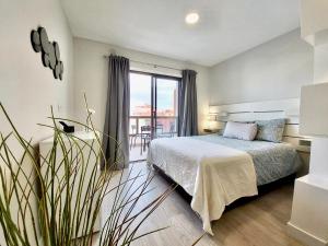 a bedroom with a bed and a large window at Apartamento Lucilú in Puerto de la Cruz