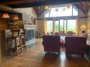 un soggiorno con tavolo, sedie e bar di Arelauquen Bungalows & Suites a San Carlos de Bariloche