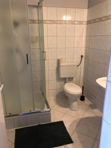 a bathroom with a toilet and a shower and a sink at U Jana in Przemyśl