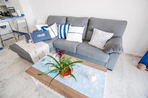 a living room with a couch and a coffee table at Seashell Beach House on the frontline of the ocean in Punta Mujeres