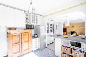 a kitchen with white cabinets and a counter top at Handsome 5 bedroom house with pool - Dodo et Tartine in Toulon