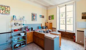a kitchen with a sink and a window at Château de Cesny-aux-Vignes in Cesny-aux-Vignes