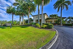 a house on a street with palm trees at Luxury Golf Villa in Beautiful Lely Resort with Pool in Naples