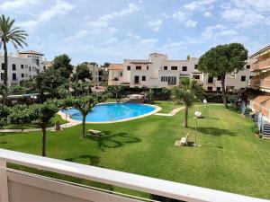 a view of a yard with a swimming pool and buildings at El Castell Orange Costa in Alcossebre