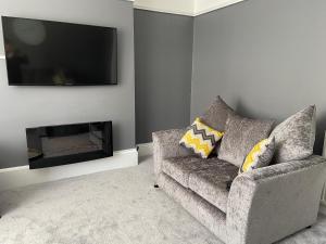 a living room with a couch and a flat screen tv at Bridge street apartment in Bridlington