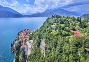 an aerial view of a town on a hill by the water at Castello di Vezio in the Village in Varenna