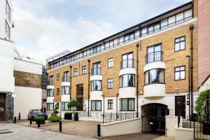 a large brick building in a city at Cheval Knightsbridge in London