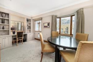 a dining room with a table and chairs at Cheval Knightsbridge in London
