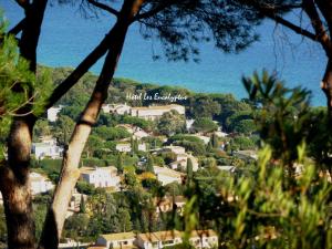 a town on a hill with a sign that reads high end agriculture at Hôtel les Eucalyptus in Cavalaire-sur-Mer