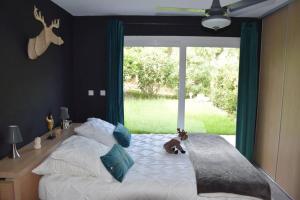 a bedroom with a bed with a stuffed animal on it at Villa luxe bord de mer avec piscine et grand jardin in Corbara +8 photos