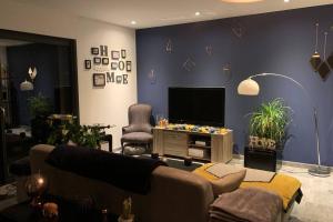 a living room with a couch and a flat screen tv at Villa luxe bord de mer avec piscine et grand jardin in Corbara