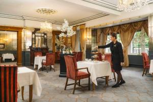 a woman standing in front of a table in a restaurant at The Reserve at Muckross Park in Killarney