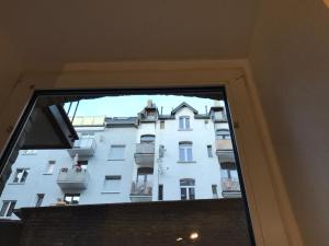 a view of a tall white building from a window at Roter Sandstein Zink in Mainz