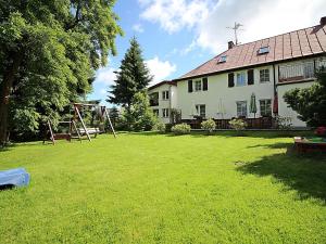 a yard with a house and a playground at Nemo Mielenko in Mielenko