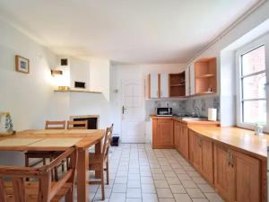 a kitchen with a wooden table and a dining room at Nemo Mielenko in Mielenko
