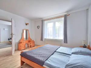 a bedroom with a bed and a large window at Nemo Mielenko in Mielenko