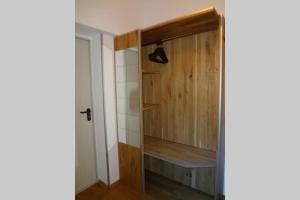 a room with a closet with a wooden door at Charmante rustikale Jägersuite mit el Kamin H2O Therme Oberhof in Oberhof +8 photos