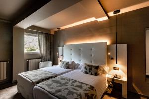 Кровать или кровати в номере Hotel & Spa Xalet Bringue