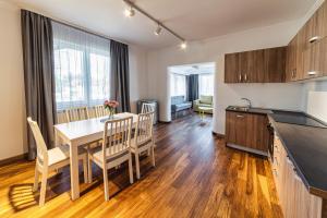 a kitchen and dining room with a table and chairs at Saga Rooms in Victoria