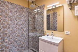 a bathroom with a shower and a toilet and a sink at Saga Rooms in Victoria +45 photos