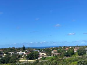a view of a town with houses and the ocean at Gussella Lodge in East London