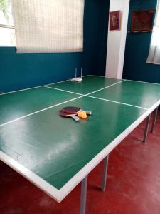una mesa de ping pong con raquetas y pelotas. en Cabaña en Fundo Huabayor en Lima