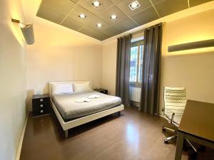 um quarto com uma cama, uma secretária e uma janela em Gemini Guest House em Roma