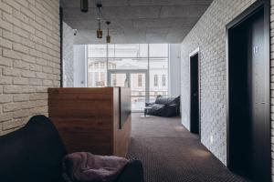 ein Wohnzimmer mit Sofa und Ziegelwand in der Unterkunft Готель хостел Rooms in Ternopil