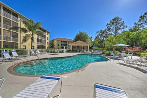 a swimming pool with lounge chairs and a hotel at Quiet Lely Resort Condo with Pool - 2 Mi to Golf! in Naples
