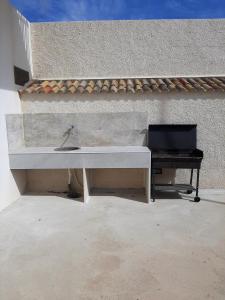 a white desk with a laptop on it next to a wall at Casa vacanze IL MANDORLO in Scicli