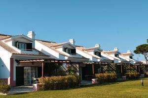 a large white building with a roof at Vila Bicuda Resort in Cascais