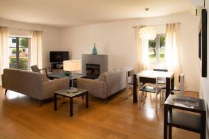 a living room filled with furniture and a fireplace at Vila Bicuda Resort in Cascais
