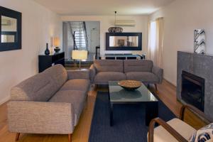 a living room with a couch and a fireplace at Vila Bicuda Resort in Cascais