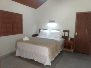 A bed or beds in a room at Pousada Flor Nativa