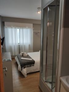 a bathroom with a bed in a room at Ecorooms SCQ estación in Santiago de Compostela