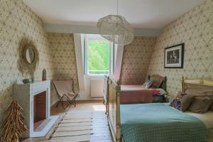 a bedroom with two beds and a chandelier at Château de Cesny-aux-Vignes in Cesny-aux-Vignes +32 photos
