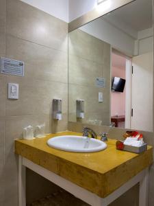 a bathroom with a sink and a large mirror at Posada de los Poetas Hotel Boutique in San Lorenzo