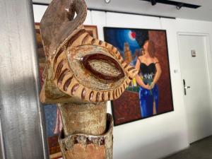 a statue of a bird standing in front of a painting at Suites Arboleda 215 in Mexico City +82 photos