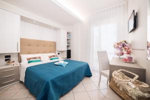 A bed or beds in a room at Viva Beach Hotel