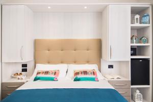 A bed or beds in a room at Viva Beach Hotel