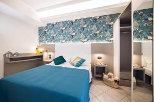 A bed or beds in a room at Viva Beach Hotel