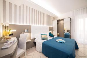 A bed or beds in a room at Viva Beach Hotel