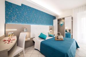 A bed or beds in a room at Viva Beach Hotel